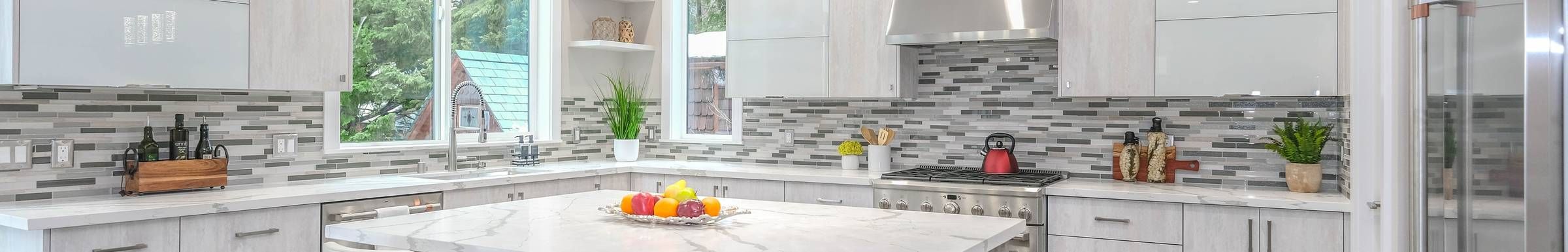 Modern kitchen with stone tile and white cabinets